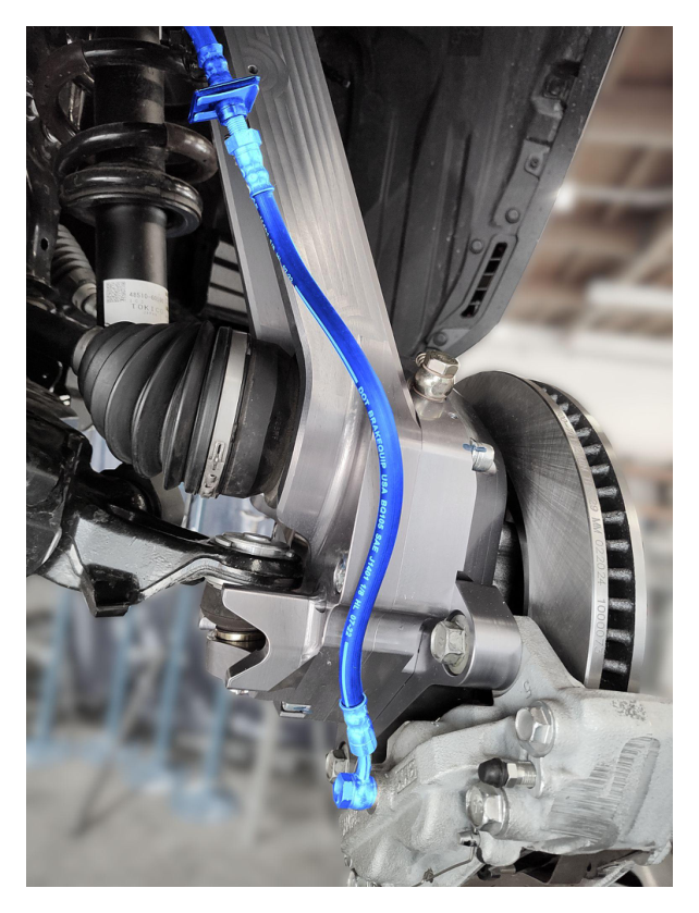 Wheel speed sensor cable routing — remove retaining bracket from upper control arm