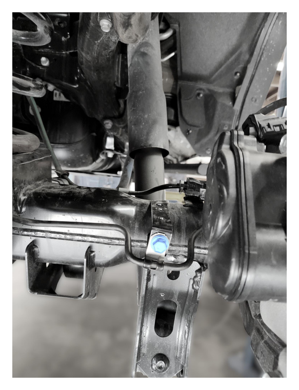 Remove hard line retaining screw to create slack