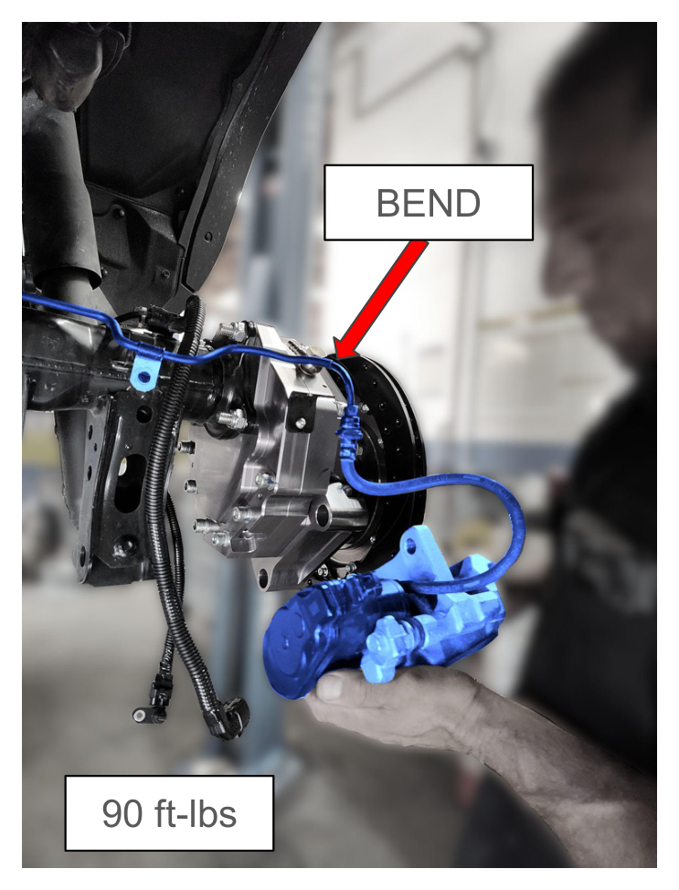 Bend hard line and install rear brake caliper — torque to 90 ft-lbs
