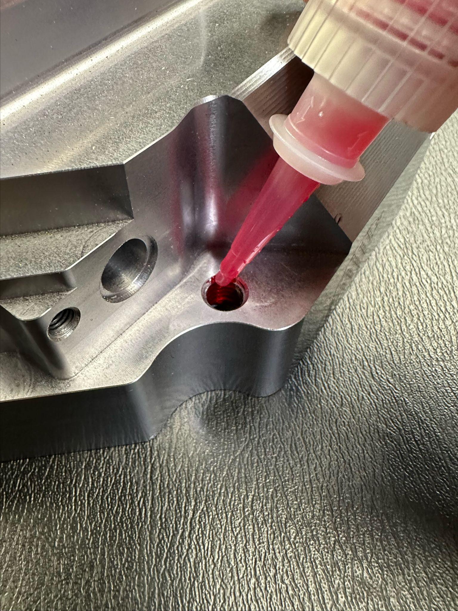 Front brake caliper bolt location